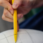 Rhian Malin decorating a mandala bottle in her workshop 2019
